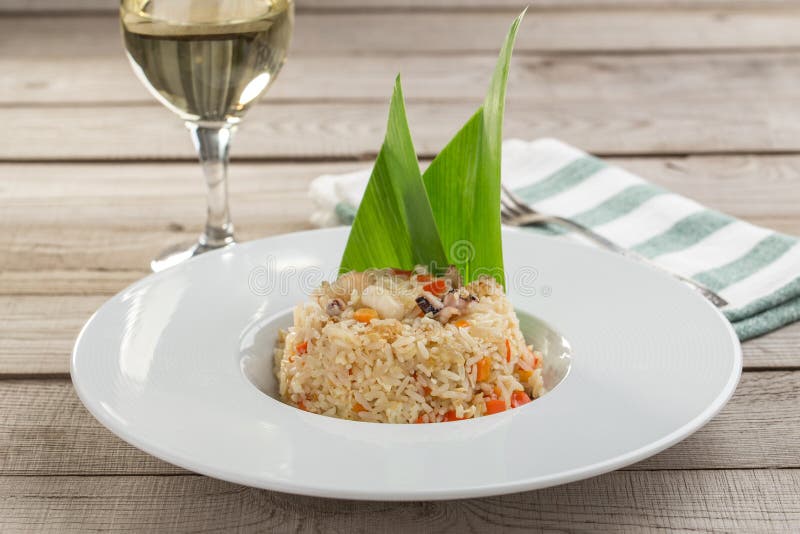 Fried Rice with Seafood and Vegetables and Glass of White Wine on