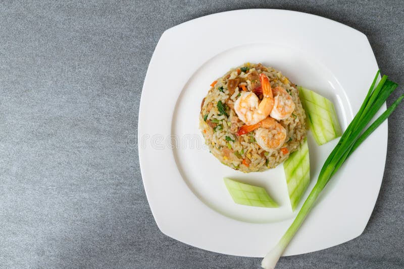 Fried Rice with Shrimp and Chinese Sausage in White Plate on Concrete