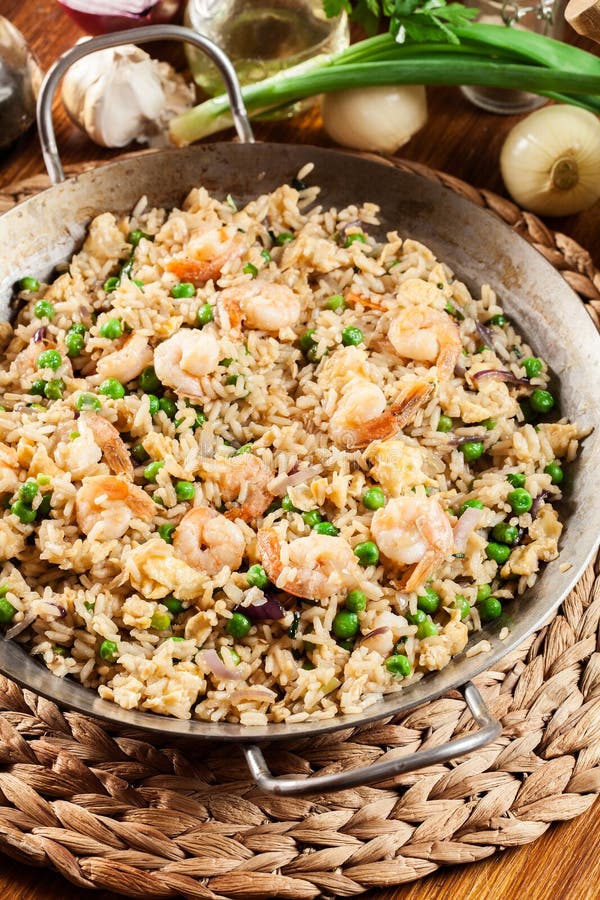 Fried Rice with Shrimp and Vegetables on a Frying Pan Stock Photo