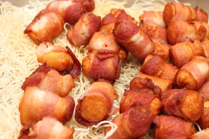 Fried sausages rolled in bacon