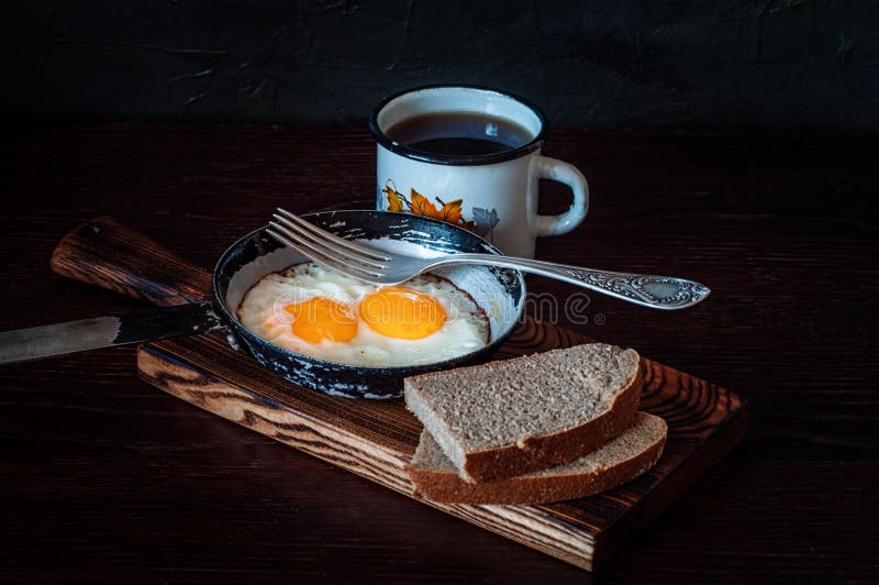 Fried Scrambled Eggs in a Vintage Pan, with Bread, Metal Mug with Tea