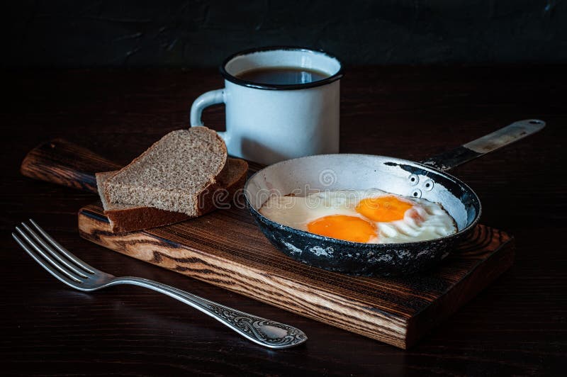 Fried Scrambled Eggs in Vintage Pan, with Bread, Old Fork, Metal Mug