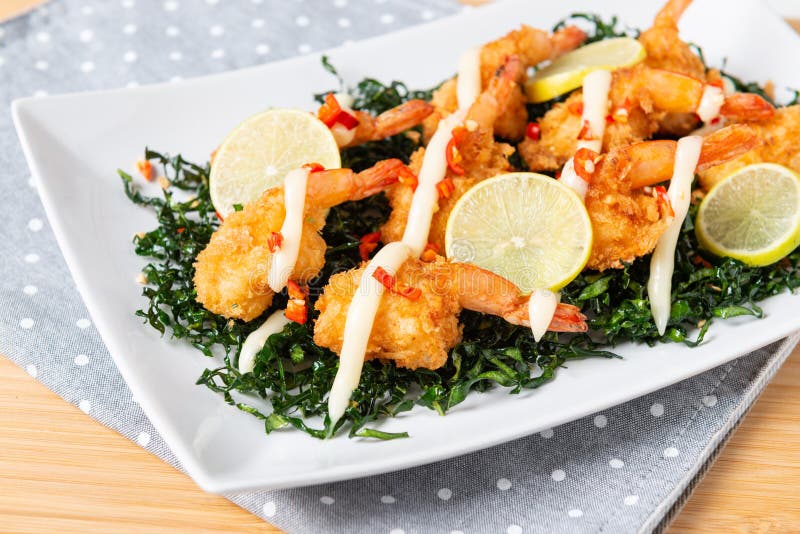 Fried Shrimp with Lime Cream Sauce and Deep Fried Kale Stock Image