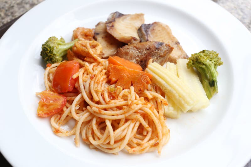 Fried Spaghetti and grilled fish on white dish.