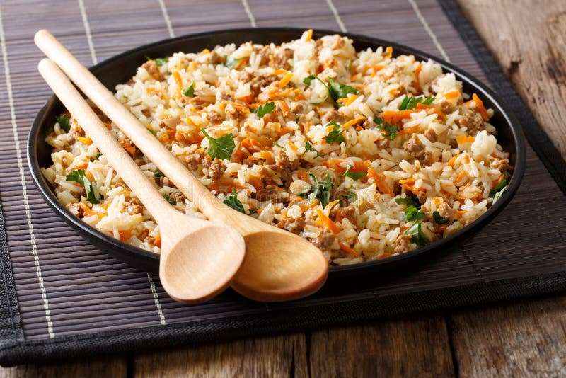 Fried spicy rice with minced meat and vegetables close-up. Horiz
