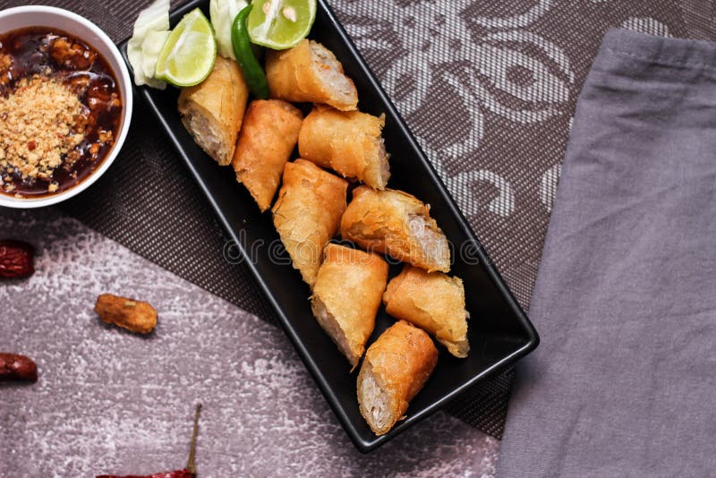 Fried Spring Rolls in a Black Plate Served with Tamarind Dipping Sauce ...