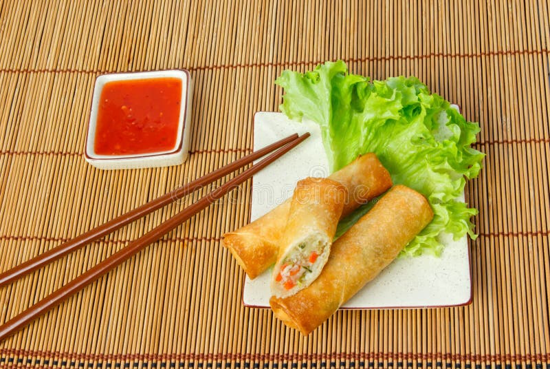 Fried Spring Rolls, One Cut, on a Plate with Chopsticks Stock Image ...