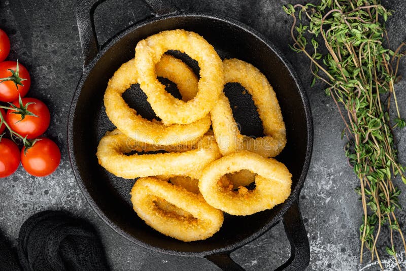 Fried Squid Rings Breaded Calamari Appetizer on Cast Iron Frying Pan