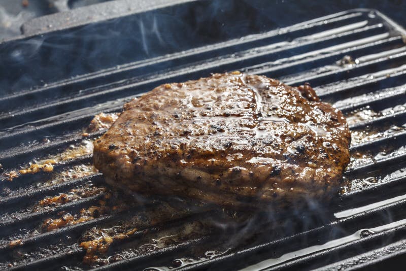 Fried steak on a grill stock image. Image of texture 56308017