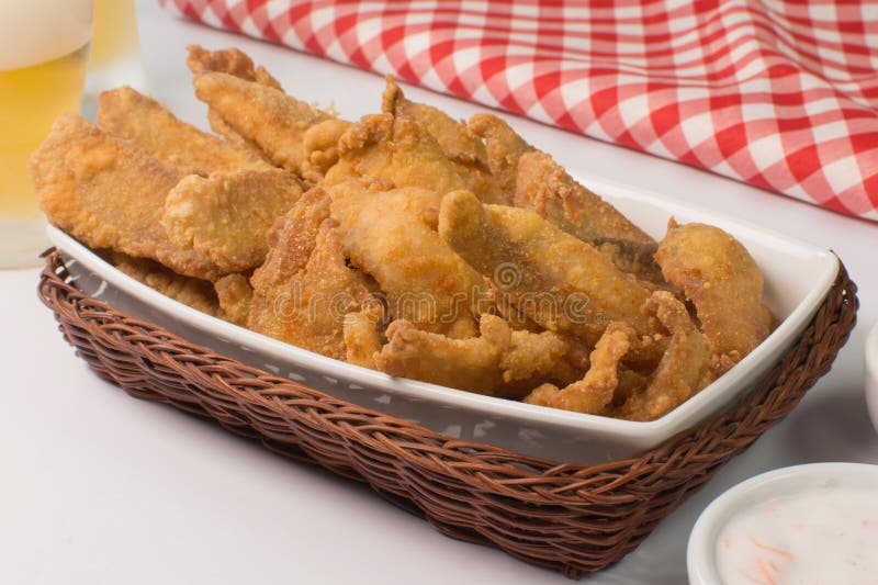 Fried Tilapia Strips in a Black Platter with Rose Pepper Sauce in