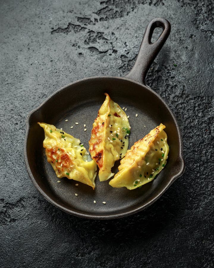 Fried Yaki Gyoza Served on Cast Iron Skillet, Pan on Rustic Black ...