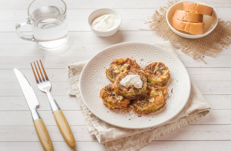 Fried Zucchini Slices in Egg Batter with Garlic on a Plate. Stock Image