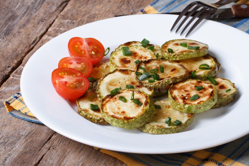 Fried Zucchini on a White Plate with Fresh Tomatoes. Stock Image