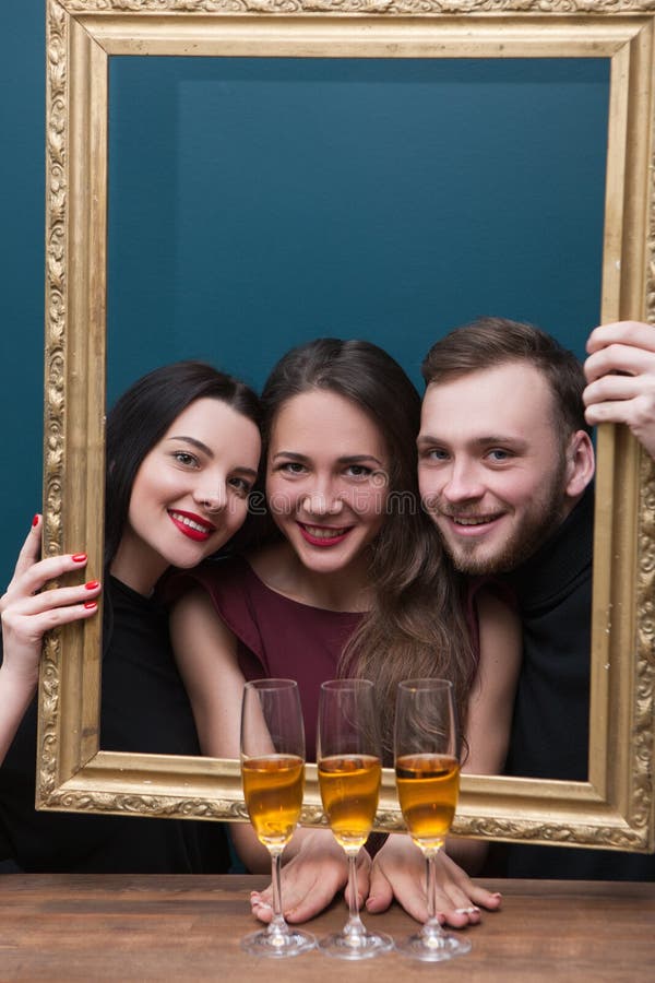 Friend birthday party. Happy live picture. Smiling people with champagne in square frame. Joyful young company on blue background with free space, happiness concept