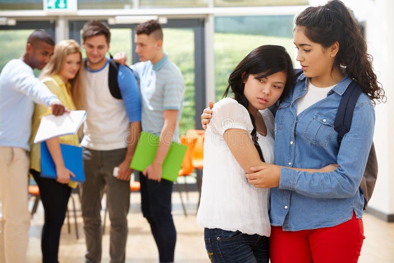 Friend Comforting Victim Of Bullying At School royalty free stock images Friend Comforting Victim Of Bullying At School royalty free stock images