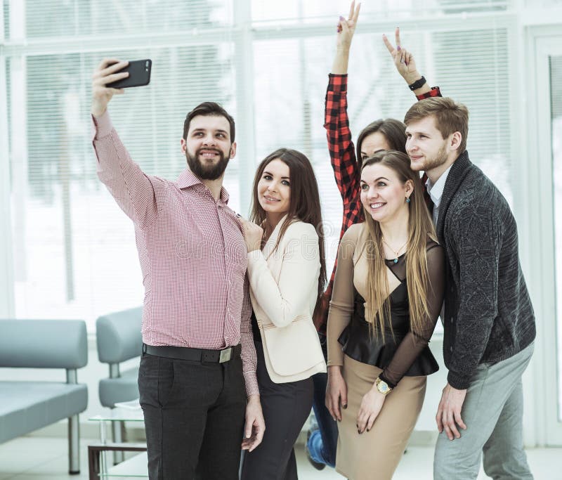Friendly Business Team Taking a Selfie while Standing Near Window in ...