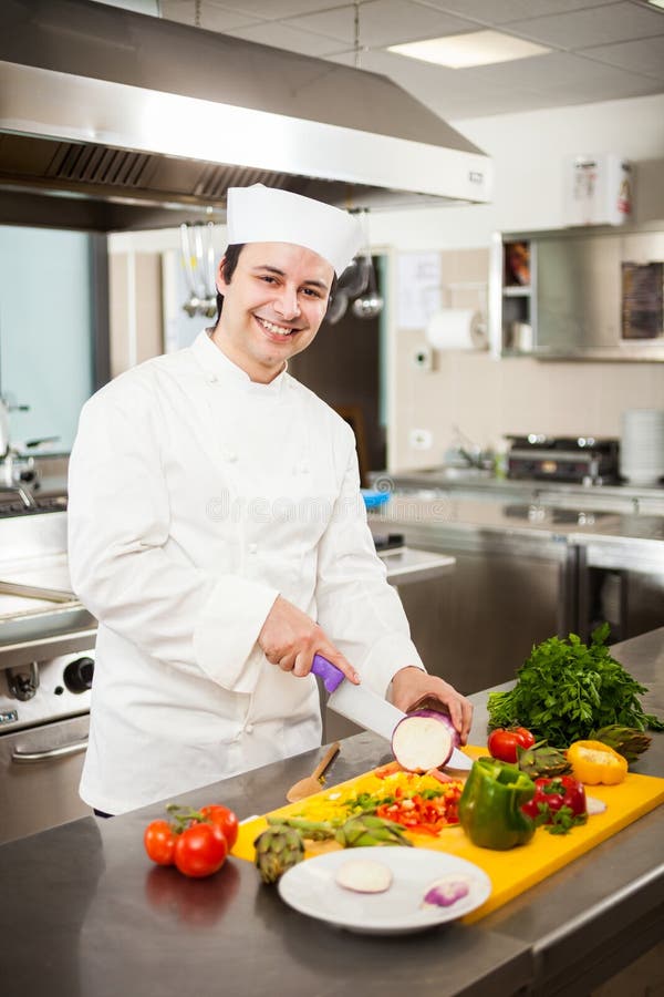 Friendly Chef Preparing Vegetables in His Kitchen. Pepper Loves Stock ...