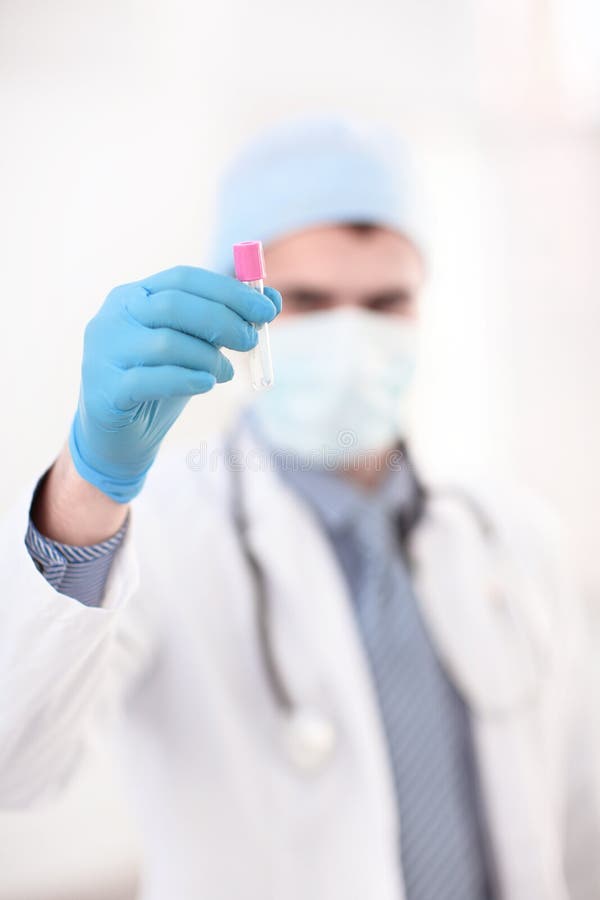 Friendly doctor -intern resarch a medical test glass with blood . royalty free stock photography Friendly doctor -intern resarch a medical test glass with blood . royalty free stock photography
