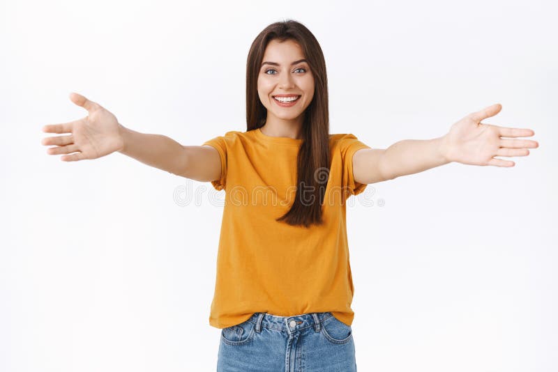 Friendly, happy and outgoing good-looking girl in yellow t-shirt, spread hands sideways to hug you, smiling cheerfully