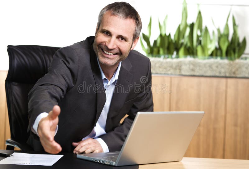 Friendly office manager stretching out hand. royalty free stock image