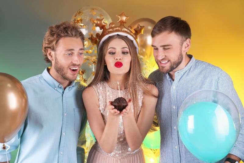 Friends with air balloons and muffin on color background stock image Friends with air balloons and muffin on color background stock image