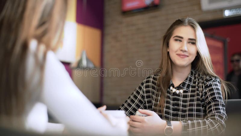 Friends in a cafe bar. Girls drink coffee in a cafe. girlfriends are sitting at a table in a cafe.