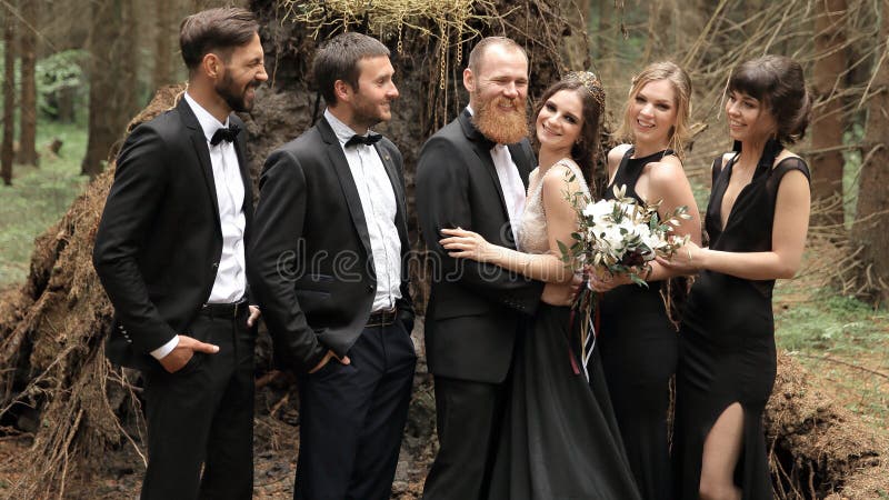 Friends congratulate the bride and groom with the wedding stock photo Friends congratulate the bride and groom with the wedding stock photo