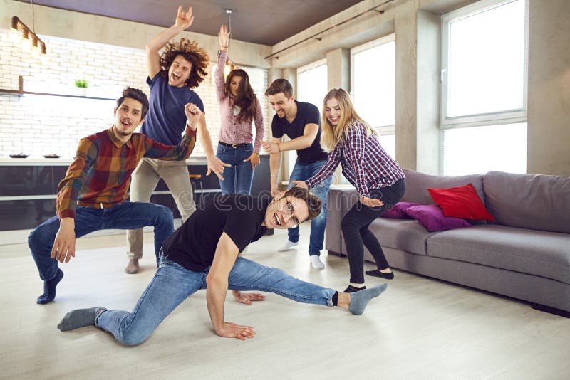 Friends dance at a student`s party in the apartment. stock images Friends dance at a student`s party in the apartment. stock images