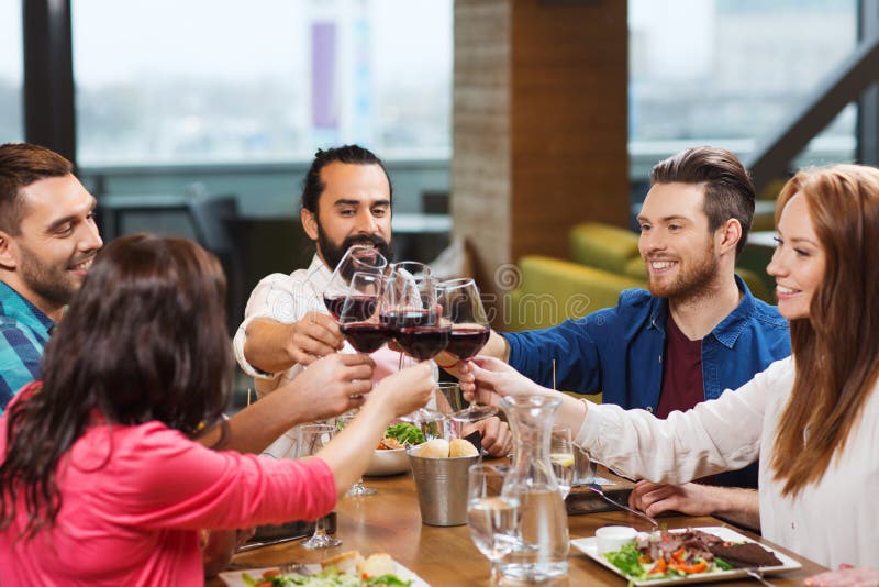 Friends dining and drinking wine at restaurant