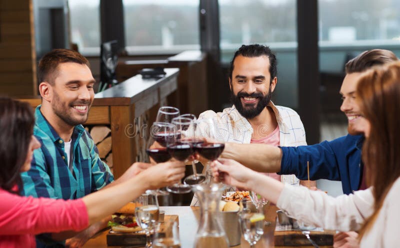 Friends Dining and Drinking Wine at Restaurant Stock Image - Image of