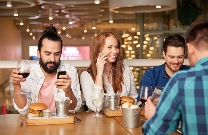 Friends dining and drinking wine at restaurant stock image Friends dining and drinking wine at restaurant stock image