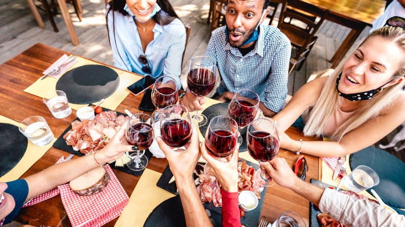 Young friends having fun outdoor clinking red wine glasses Stock Photo by  MirkoVitali