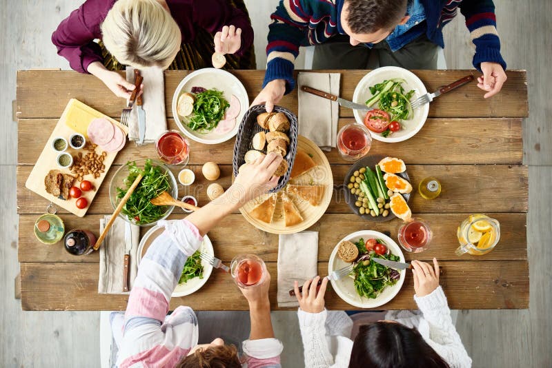 Friends Eating at Dinner Table Stock Image - Image of friends, table