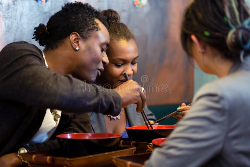 Friends eating noodle soup in Japanese Restaurant