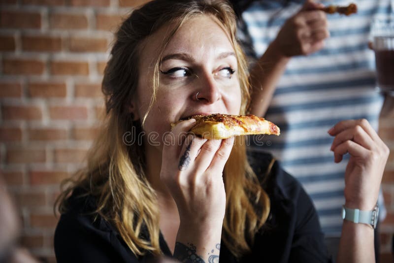 Three Friends Eating Pizza Stock Photo, Picture and Royalty Free Image.  Image 10735477.