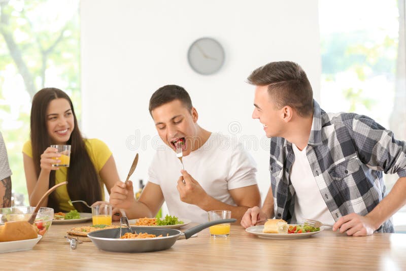 Friends Eating at Table in Kitchen Stock Photo Image of friendship