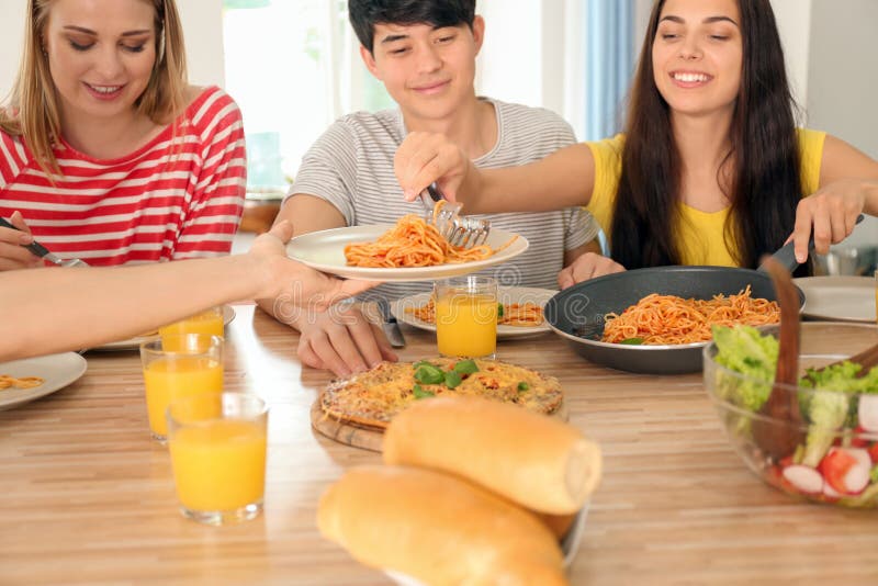 Friends Eating at Table in Kitchen Stock Photo Image of friendship