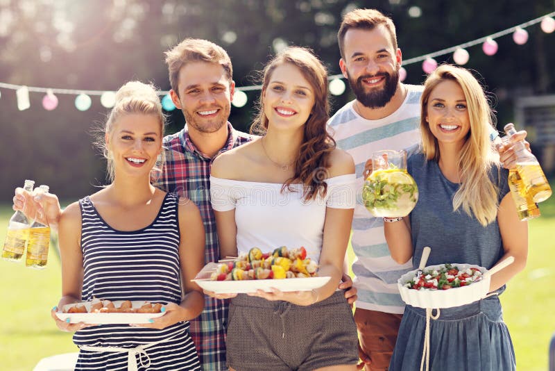 Friends having barbecue party in backyard royalty free stock images Friends having barbecue party in backyard royalty free stock images