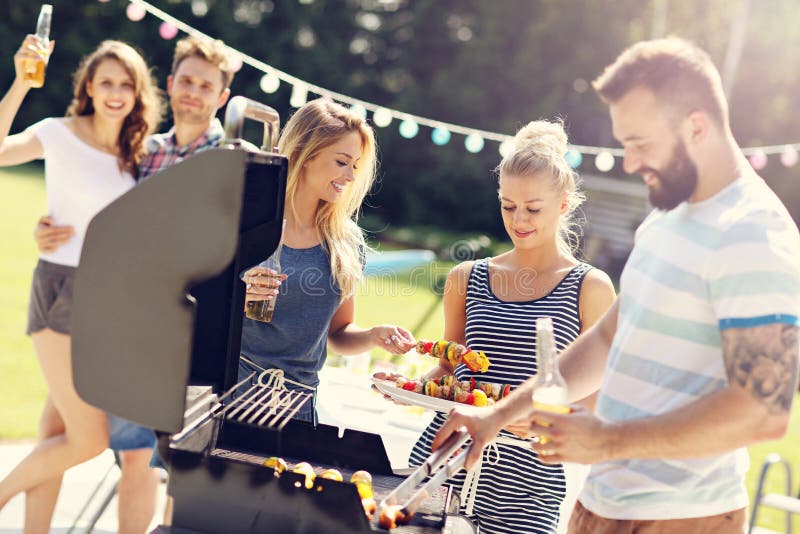 Friends Having Barbecue Party in Backyard Stock Image Image of