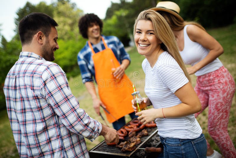 Friends Having a Barbecue Party and Fun in Nature Stock Photo Image