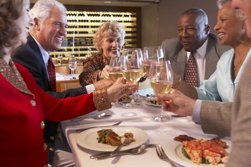 Friends Having Dinner at a Restaurant Stock Photo - Image of older