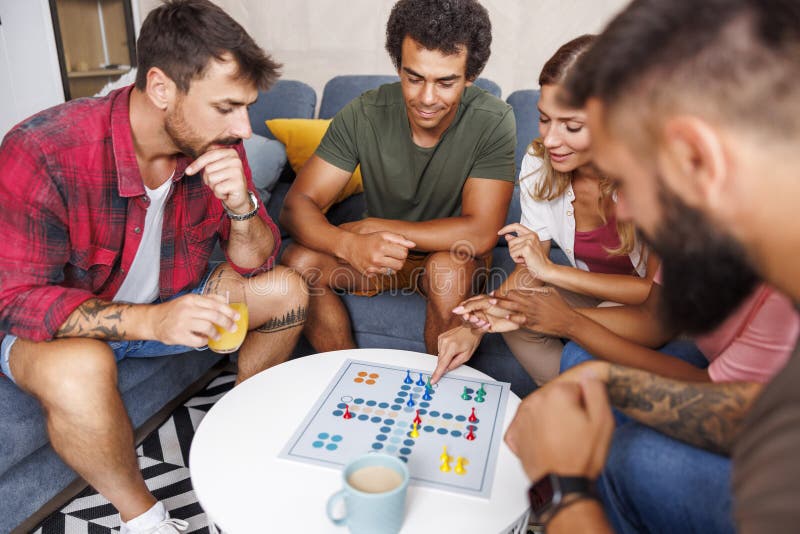 Friends Having Fun Playing Ludo Board Game while Spending Leisure