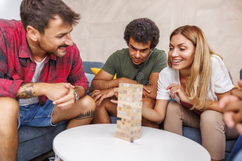 Friends Having Fun Playing Ludo Board Game while Spending Leisure