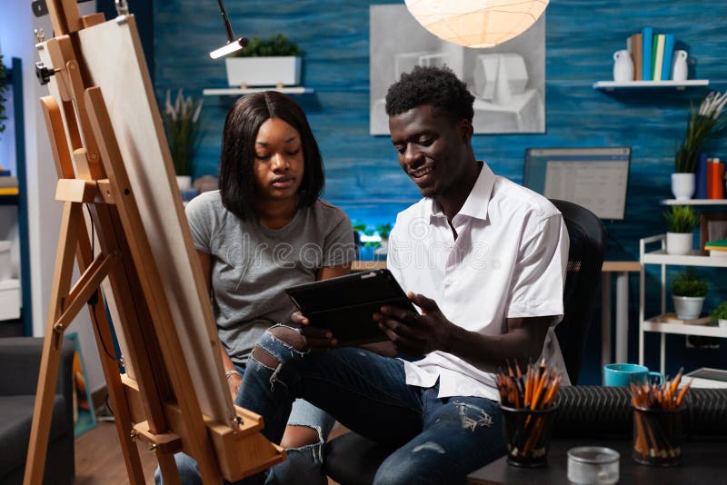 Friends having good time learning new sketching abilities stock photography