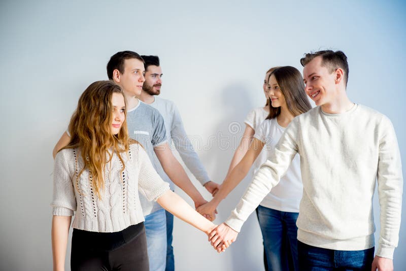 Friends holding hands stock photo. Image of excitement 92109048