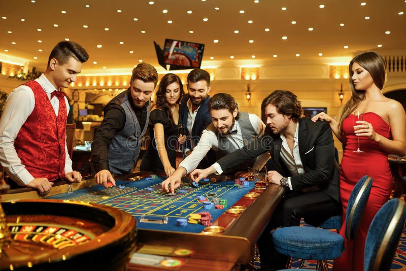 Friends gambling at a roulette table in a casino