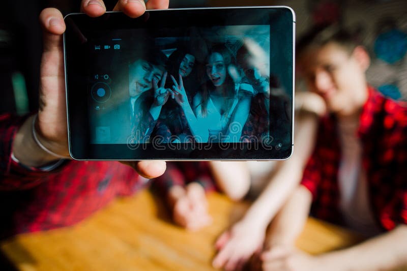 Friends make selfie in a cafe. Two boys and two girls make selfie in cafe royalty free stock images Friends make selfie in a cafe. Two boys and two girls make selfie in cafe royalty free stock images