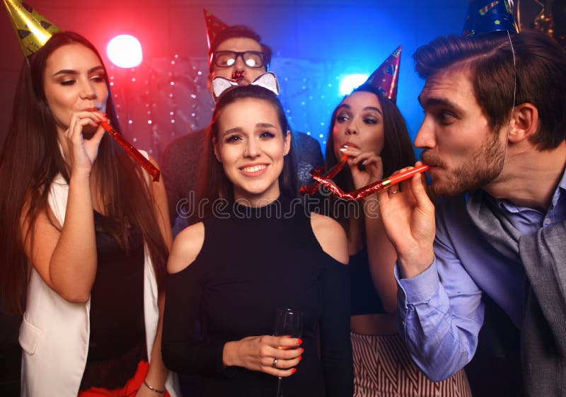 Friends making big party in the night. Five people throwing confetti and drinking champagne. royalty free stock photo Friends making big party in the night. Five people throwing confetti and drinking champagne. royalty free stock photo