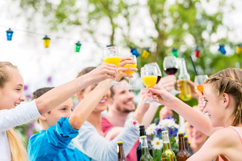 Friends and neighbors toasting on garden party