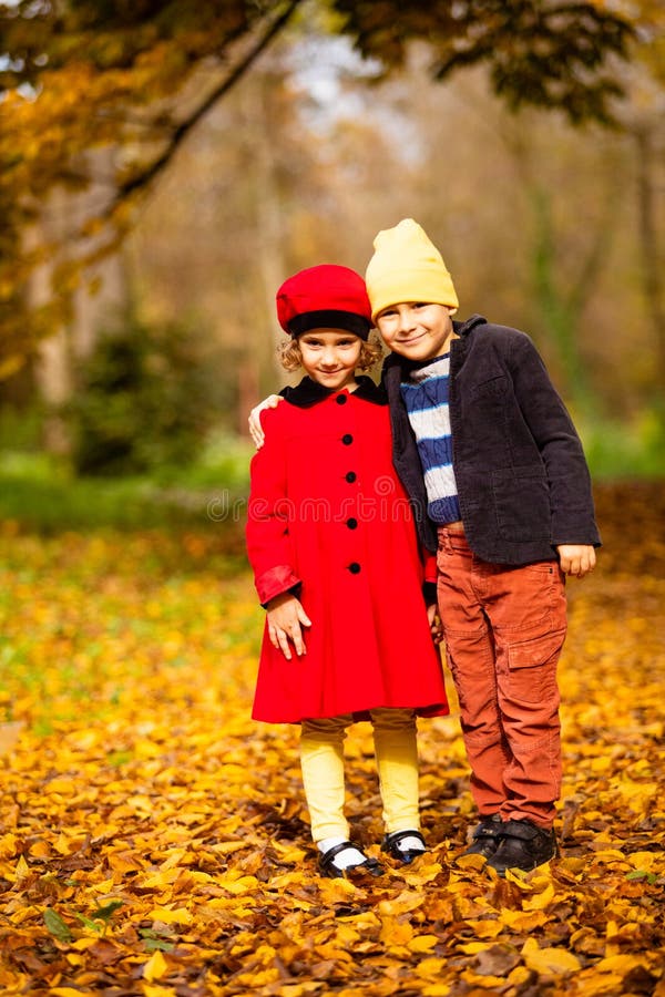 Friends play in a beautiful autumn park together stock photography